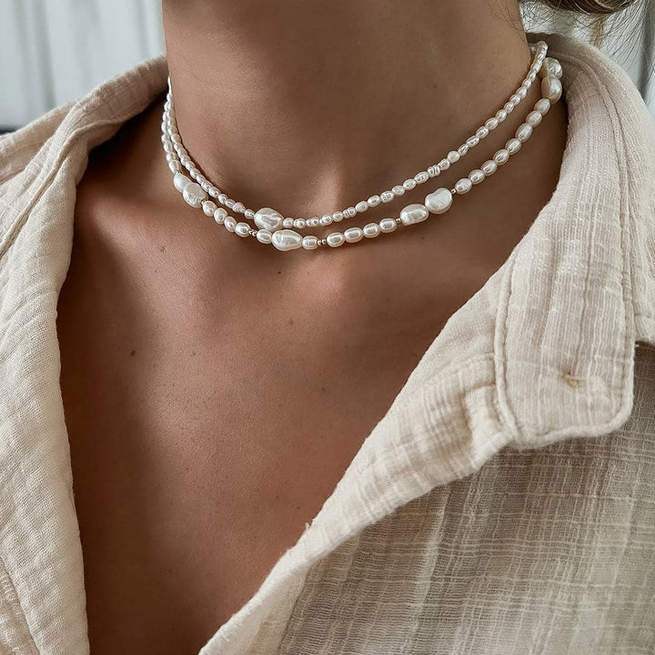Close-up of a model wearing the Monaco Necklace with mixed pearl sizes and tiny gold beads.
