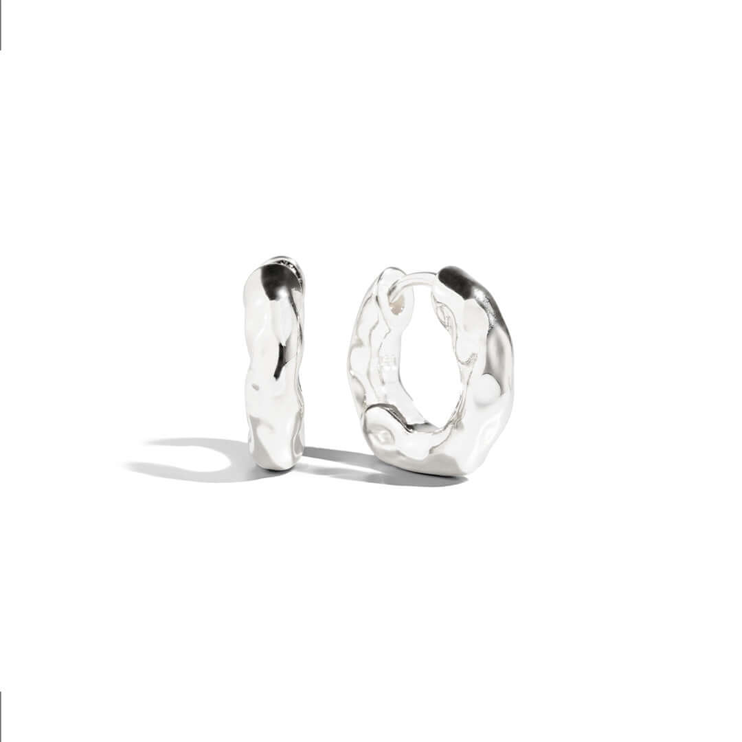 Asi Earrings showcasing unique textured silver design with modern appeal and elegant finish.