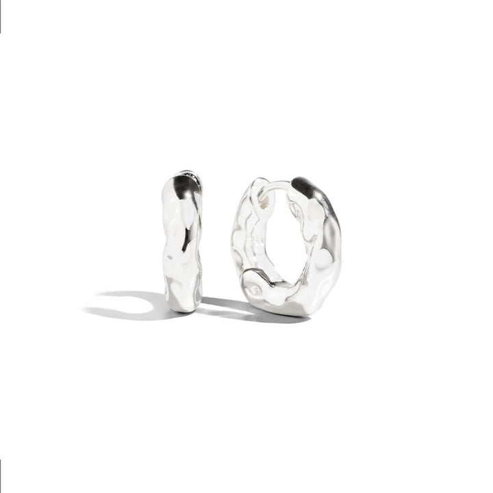 Asi Earrings showcasing unique textured silver design with modern appeal and elegant finish.