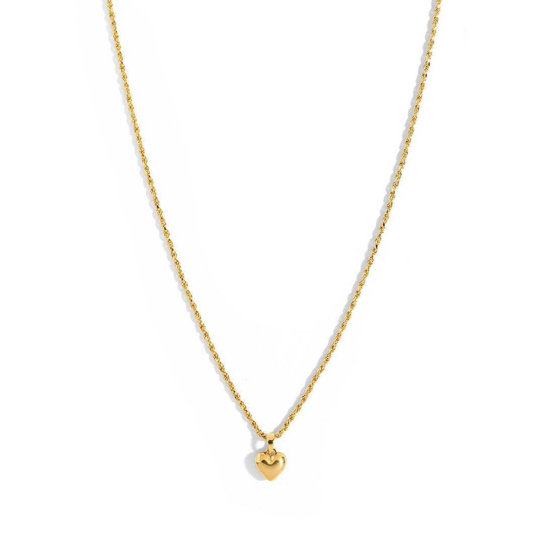 Mali Heart Necklace featuring a delicate braided chain with a small heart pendant, perfect for everyday wear.