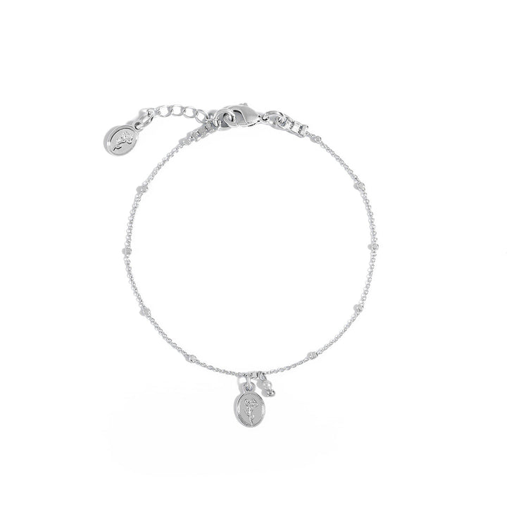 Flory Bracelet featuring delicate chain and oval charm with rose and pearl accents.