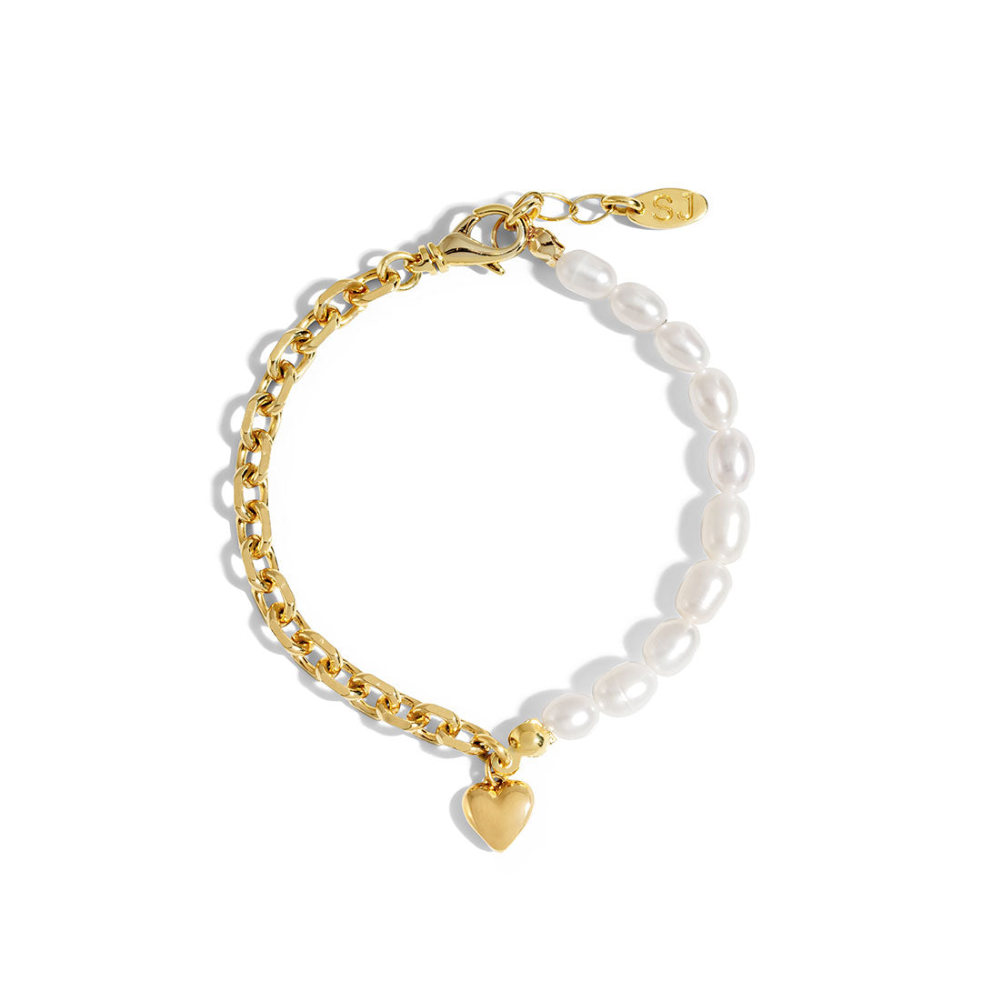 Nina Bracelet featuring gold chain and natural pearls with heart charm, stylish for layering or wearing alone.
