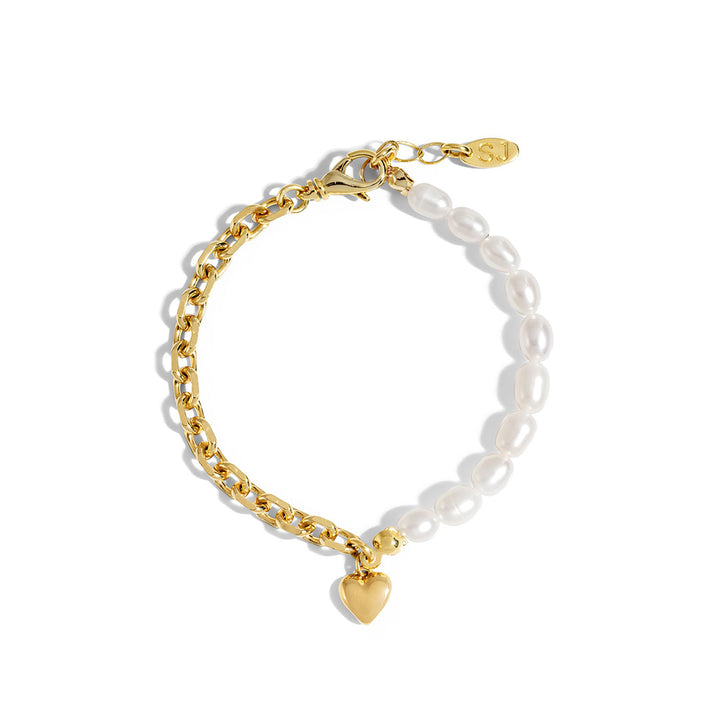 Nina Bracelet featuring gold chain and natural pearls with heart charm, stylish for layering or wearing alone.