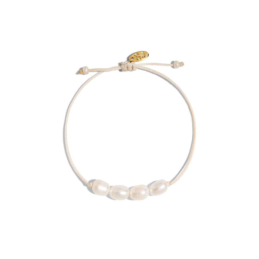 Ariel Bracelet featuring freshwater pearls on a handmade cord in a neutral tone, adjustable for a perfect fit.