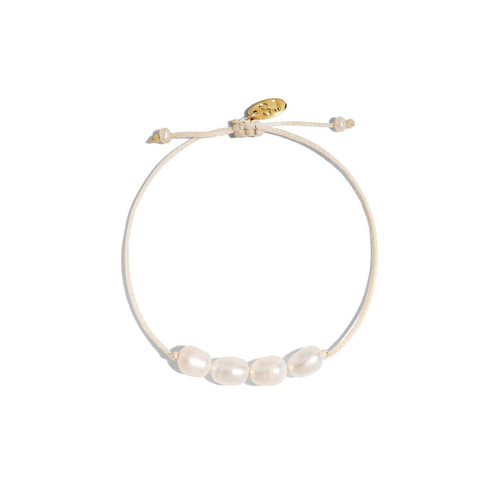 Ariel Bracelet featuring freshwater pearls on a handmade cord in a neutral tone, adjustable for a perfect fit.