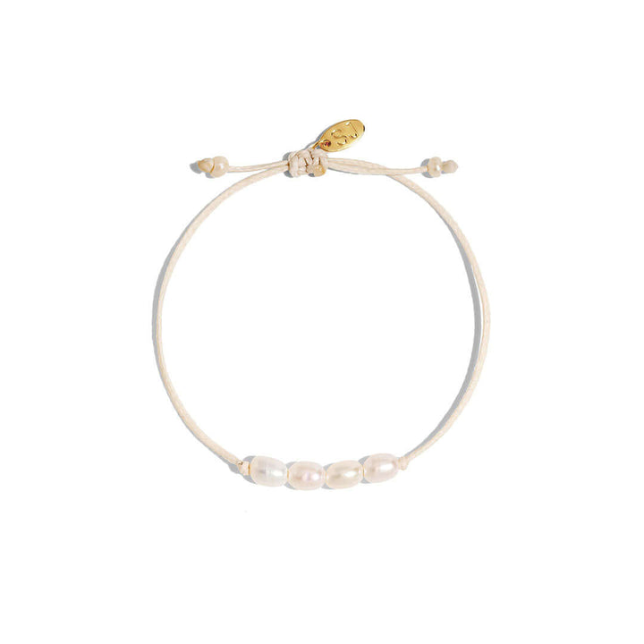 Ariel Bracelet handmade cord bracelet featuring freshwater pearls with adjustable wax-coated thread in neutral tone.