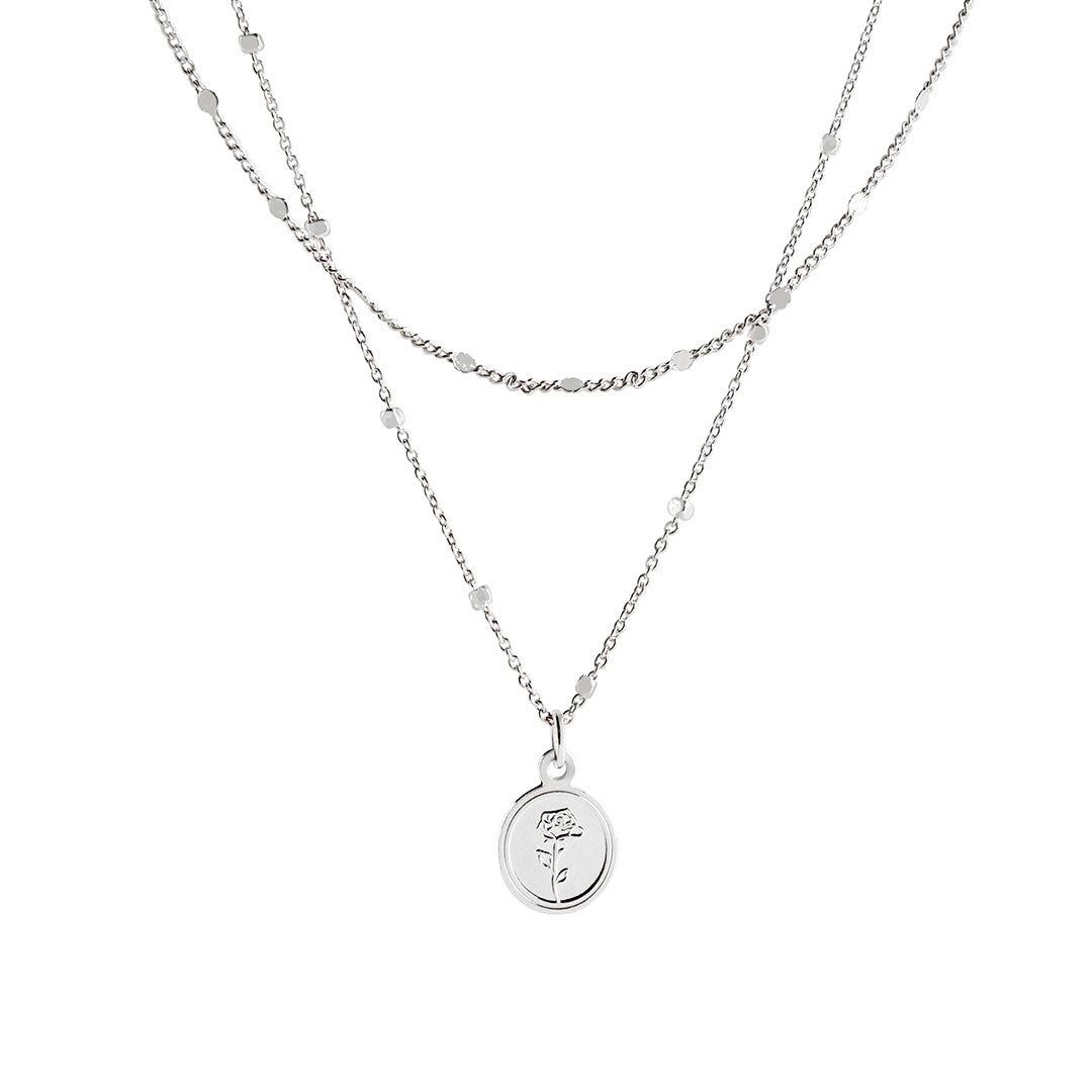 Flory Necklace featuring a double-layered design with a round rose-embossed pendant and delicate chains.