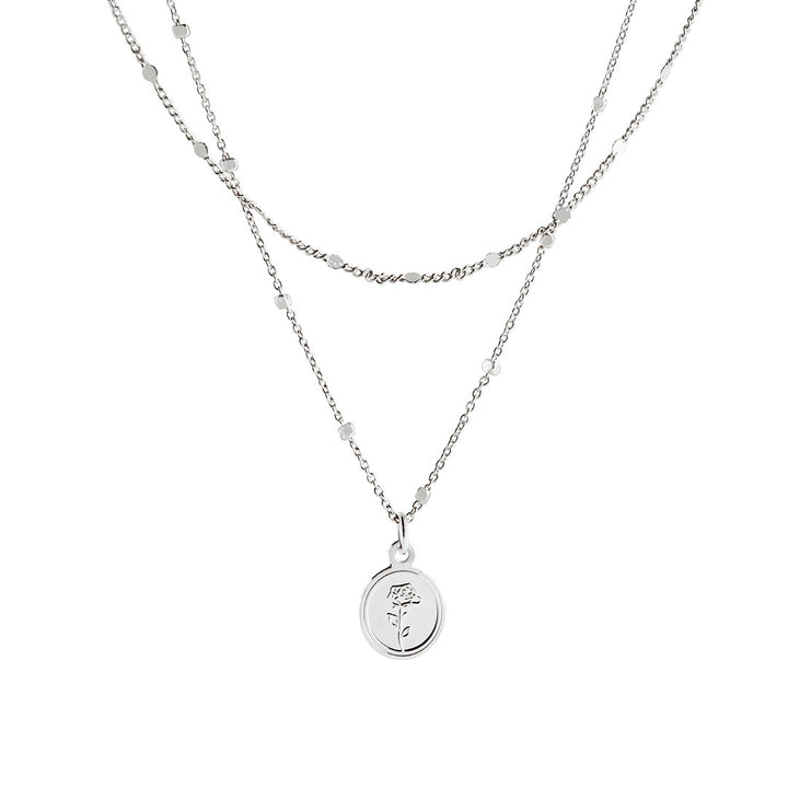 Flory Necklace featuring a double-layered design with a round rose-embossed pendant and delicate chains.