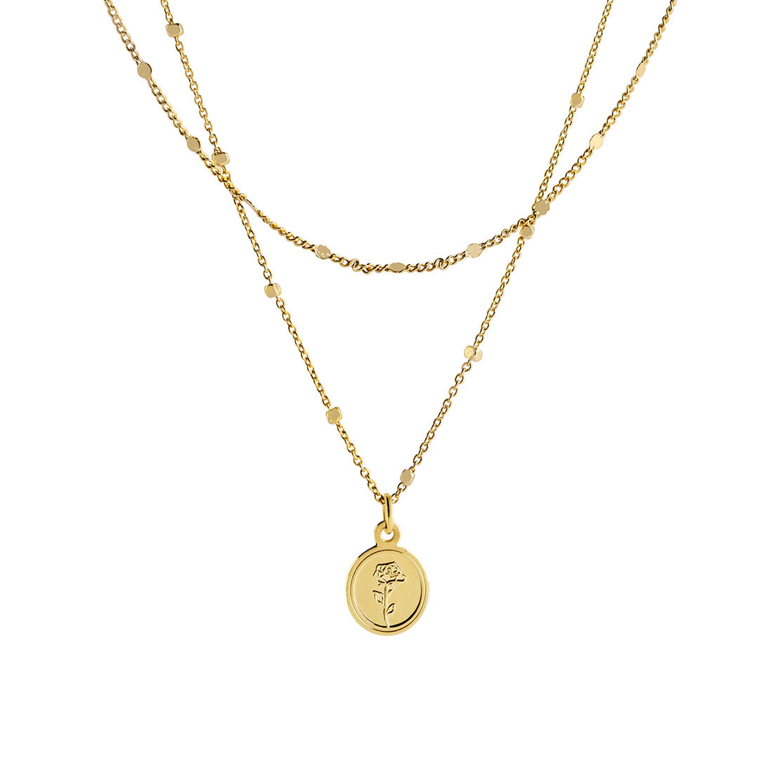 Flory Necklace featuring a double-layer gold chain with a round pendant embossed with a rose detail.