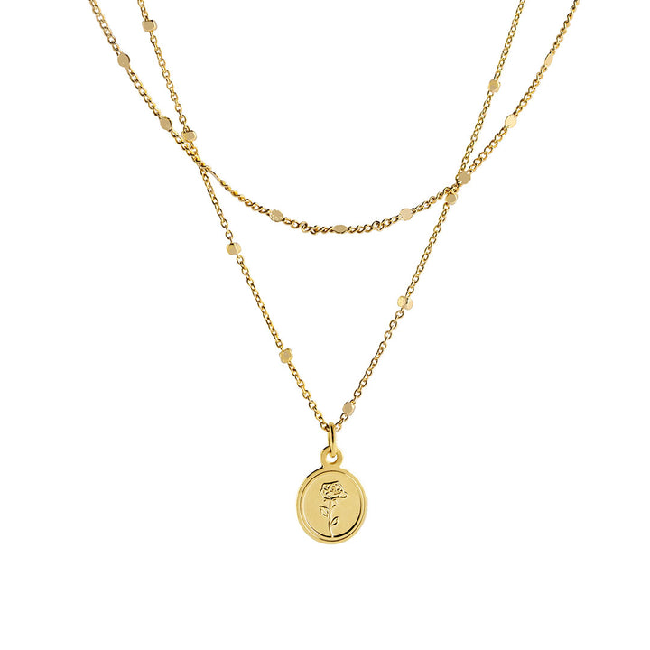 Flory Necklace featuring a double-layer gold chain with a round pendant embossed with a rose detail.