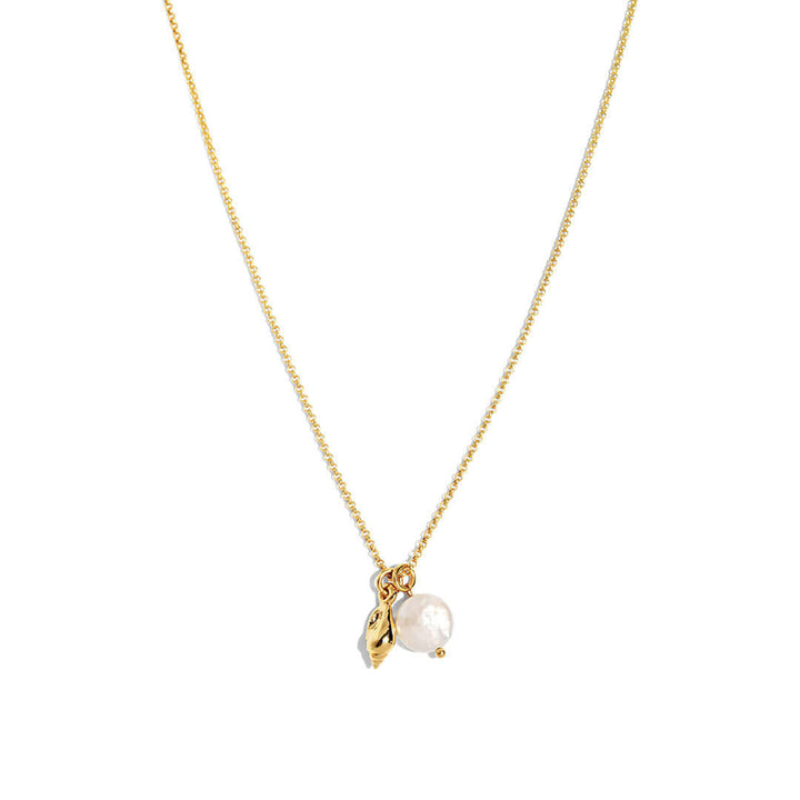 Maya Necklace featuring a delicate chain, seashell charm, and freshwater pearl pendant for effortless elegance.