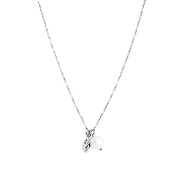 Maya Necklace featuring a delicate chain, seashell charm, and freshwater pearl pendant for effortless elegance.
