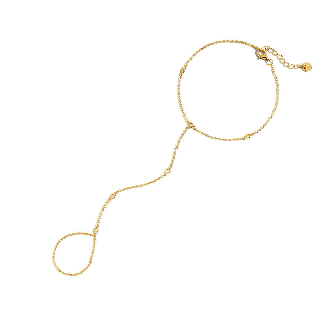 Sol Hand Chain Bracelet featuring a gold fine chain connecting wrist and finger with elegant design.