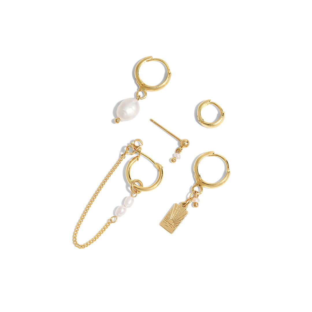 Sunset Earrings Set featuring gold hoops, pearls, and an engraved sunset charm, perfect for stylish everyday wear.