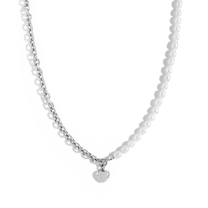 Nina Necklace featuring structured link chain and natural pearls, perfect for edgy and elegant styling.