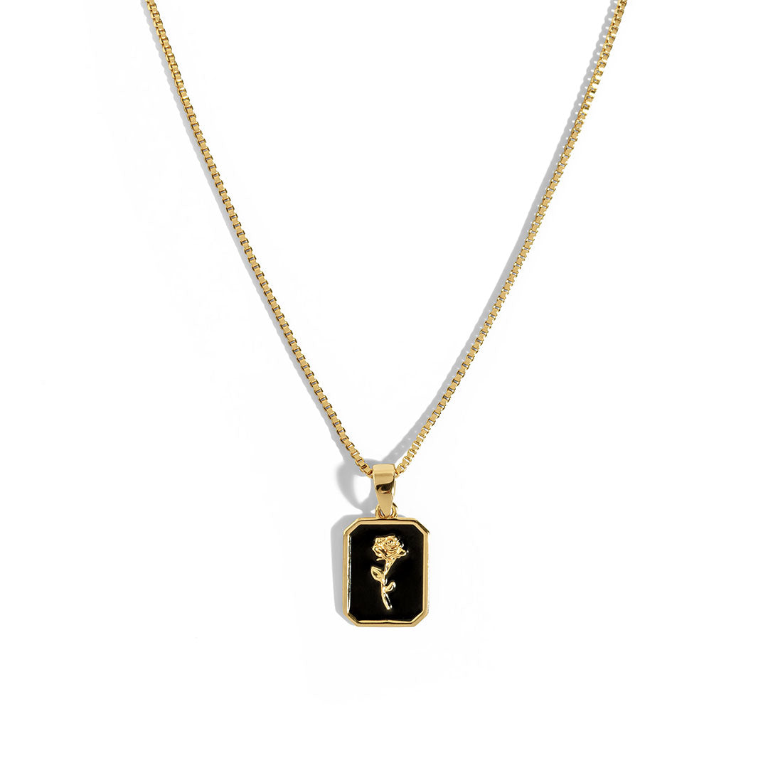 Black Rose Necklace featuring a gold chain and an iconic black pendant with a delicate rose design.