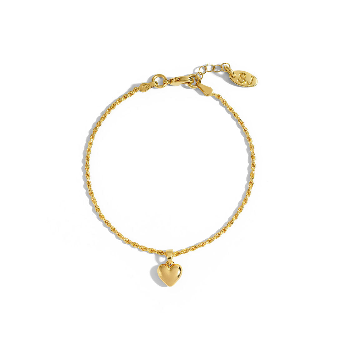 Mali Heart Bracelet featuring a delicate braided chain and heart charm, perfect for stacking or wearing alone.