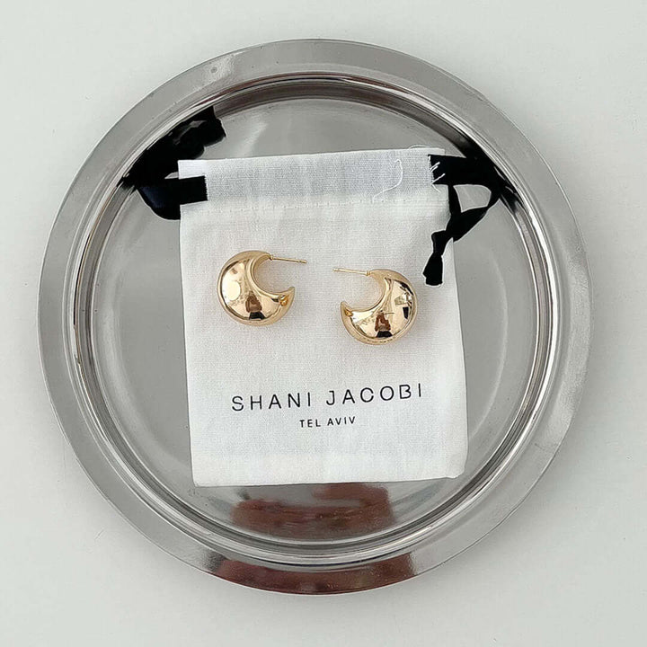 Luna Earrings displayed on a plate, featuring a bold and comfy design, perfect for any outfit.