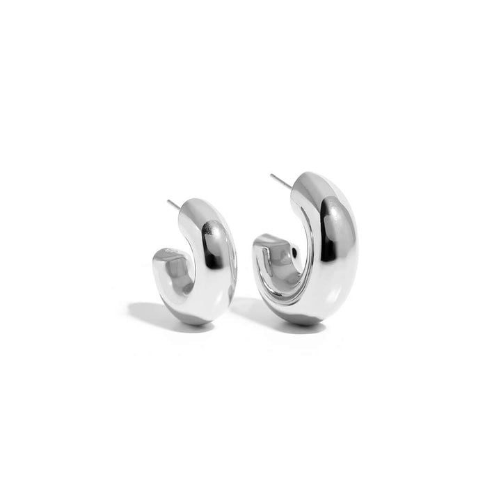 Mango Earrings featuring a sleek and modern design in shiny silver metal.