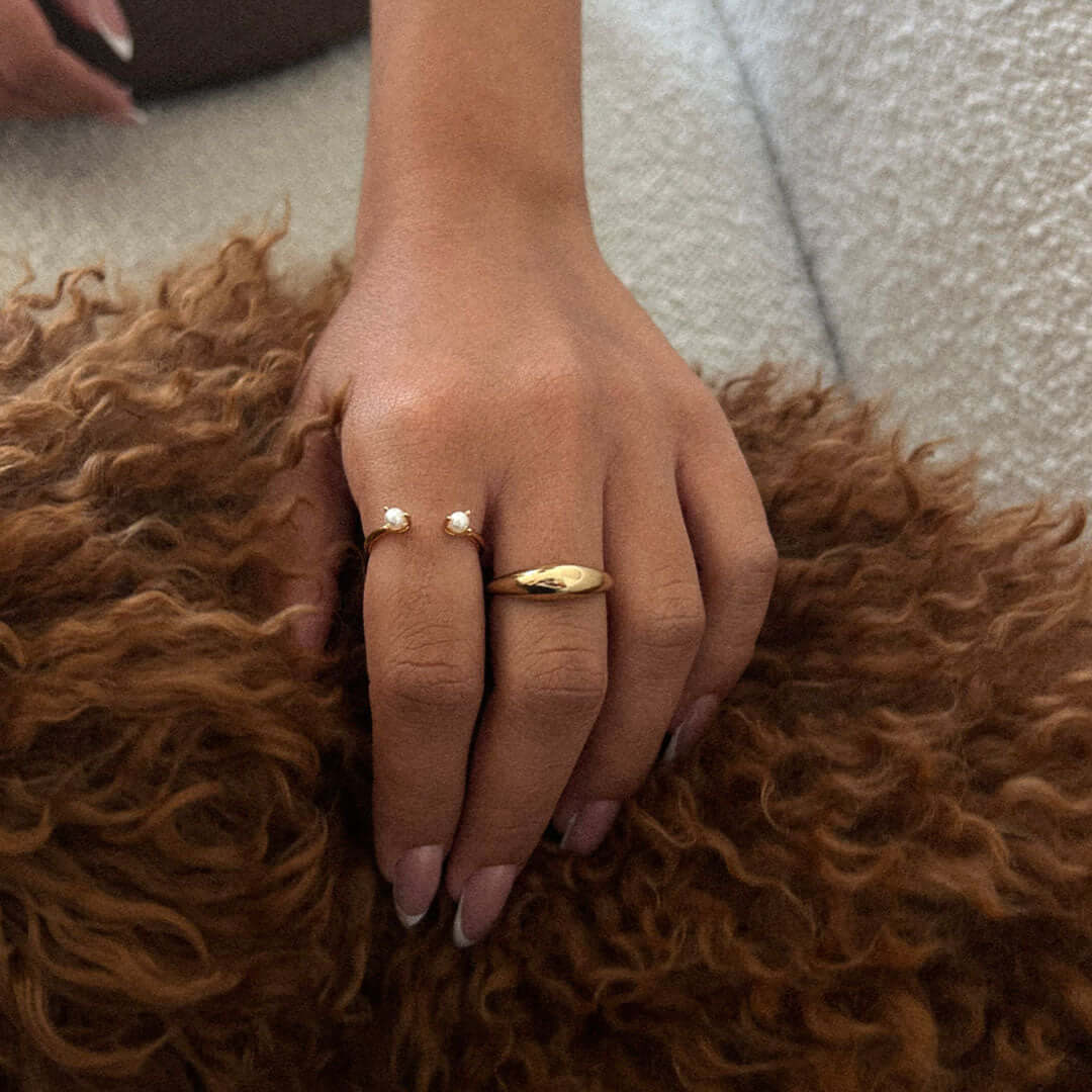 Queen Pearl Ring with freshwater pearls worn on a hand, showcasing its elegant design and adjustable fit.