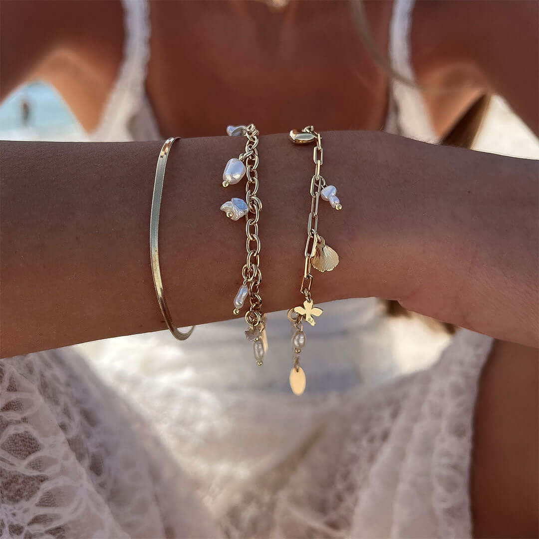 Gold Story Bracelet by Shani Jacobi with pearls and charms for a feminine touch, perfect for stacking or gifting.