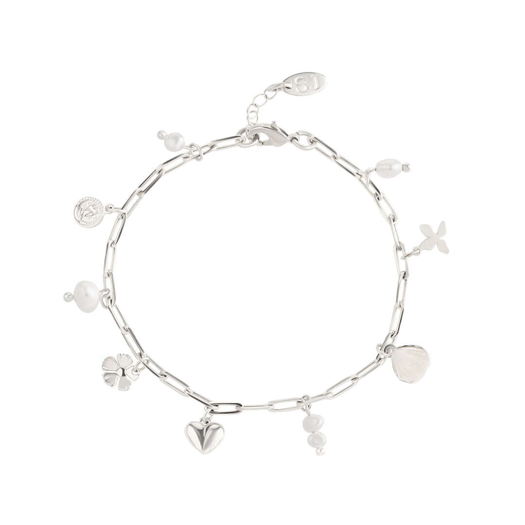 Shani Jacobi Story Bracelet with silver chain, pearls, and playful charms including hearts and seashells.