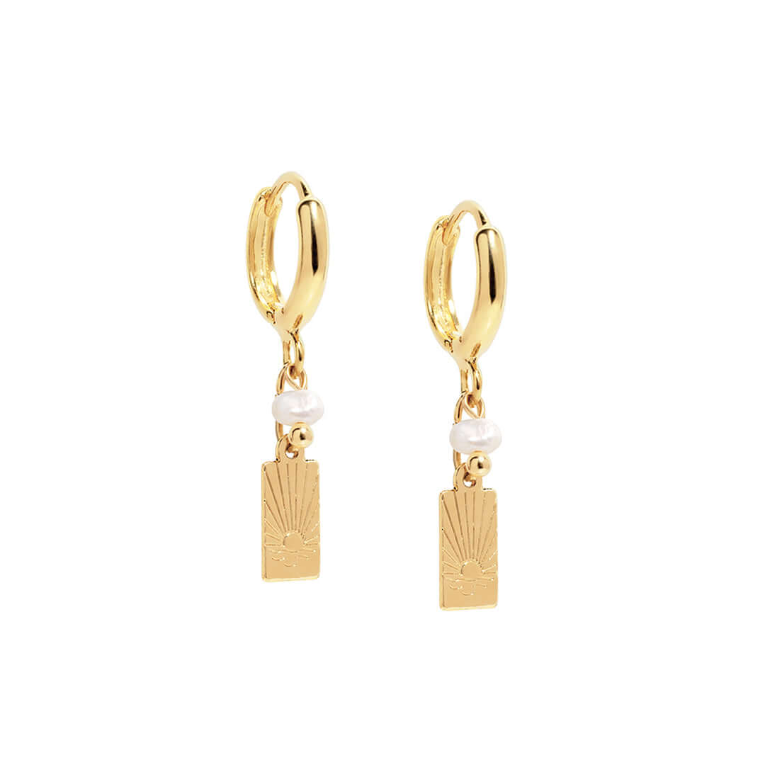 Sunny Earrings featuring a dainty drop design with gold charm and pearl accents, perfect for casual and dressy outfits.