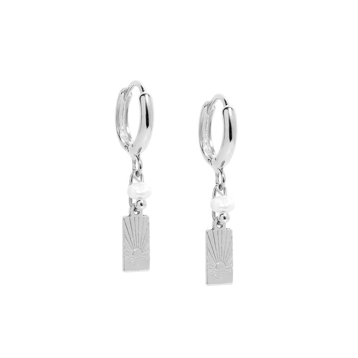 Sunny Earrings featuring a dainty drop design with sunset-inspired charm and a pearl accent.